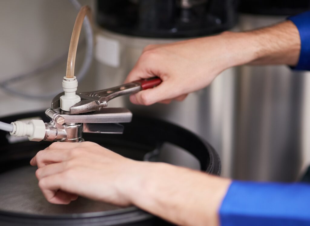Climatisation chauffage et plomberie à Lyon Ankial - cropped shot of a handyman repairing a pipe on a water heater Ankial Ankial https://climatisation-lyon.com climatisation multi split climatisation multi split